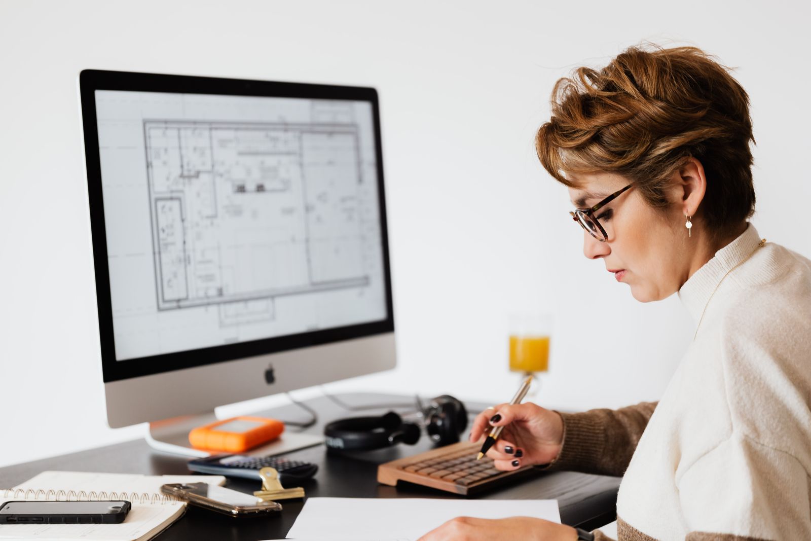 A contractor at a workstation reviewing construction plans