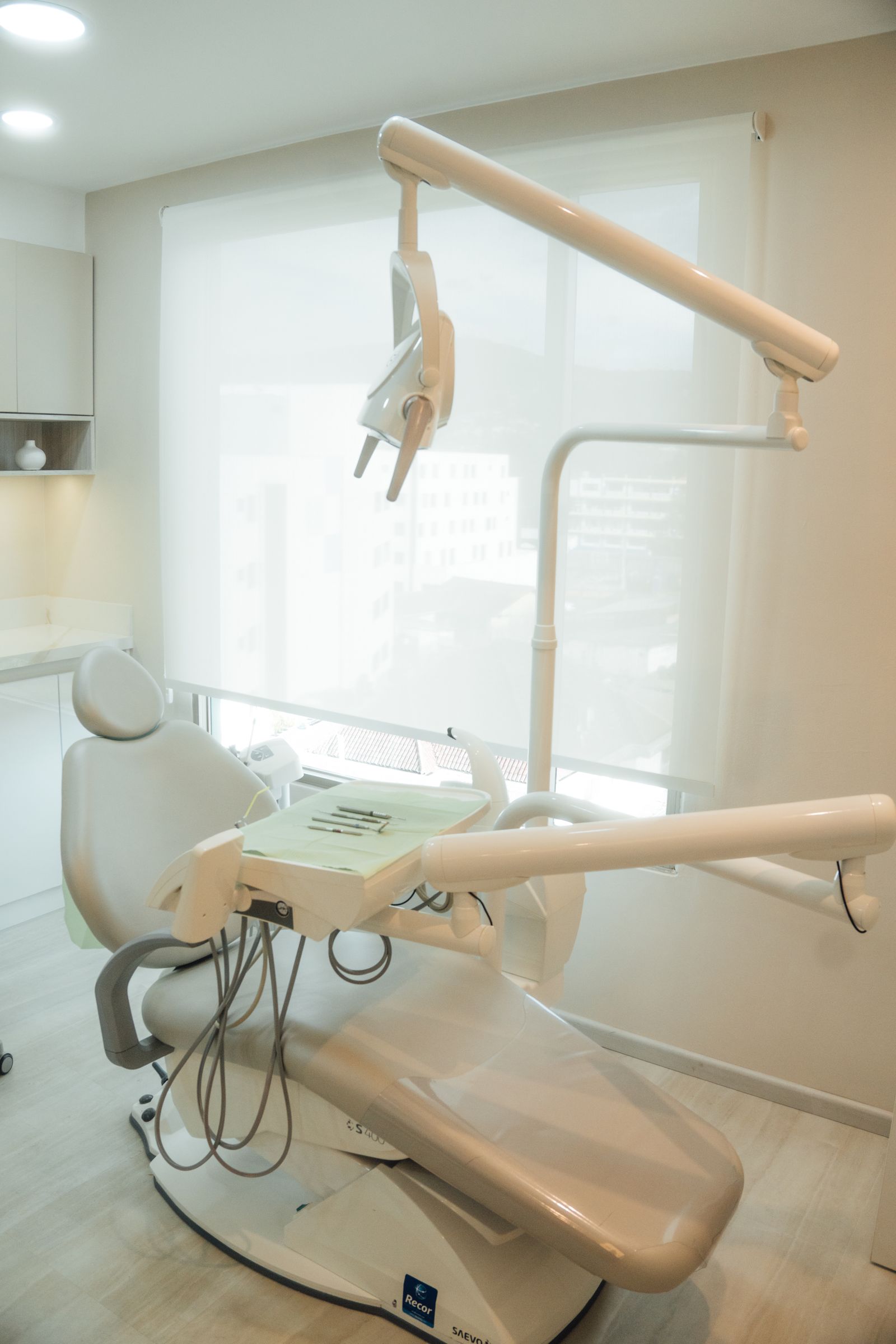 A bright, modern dental operatory beside a large window