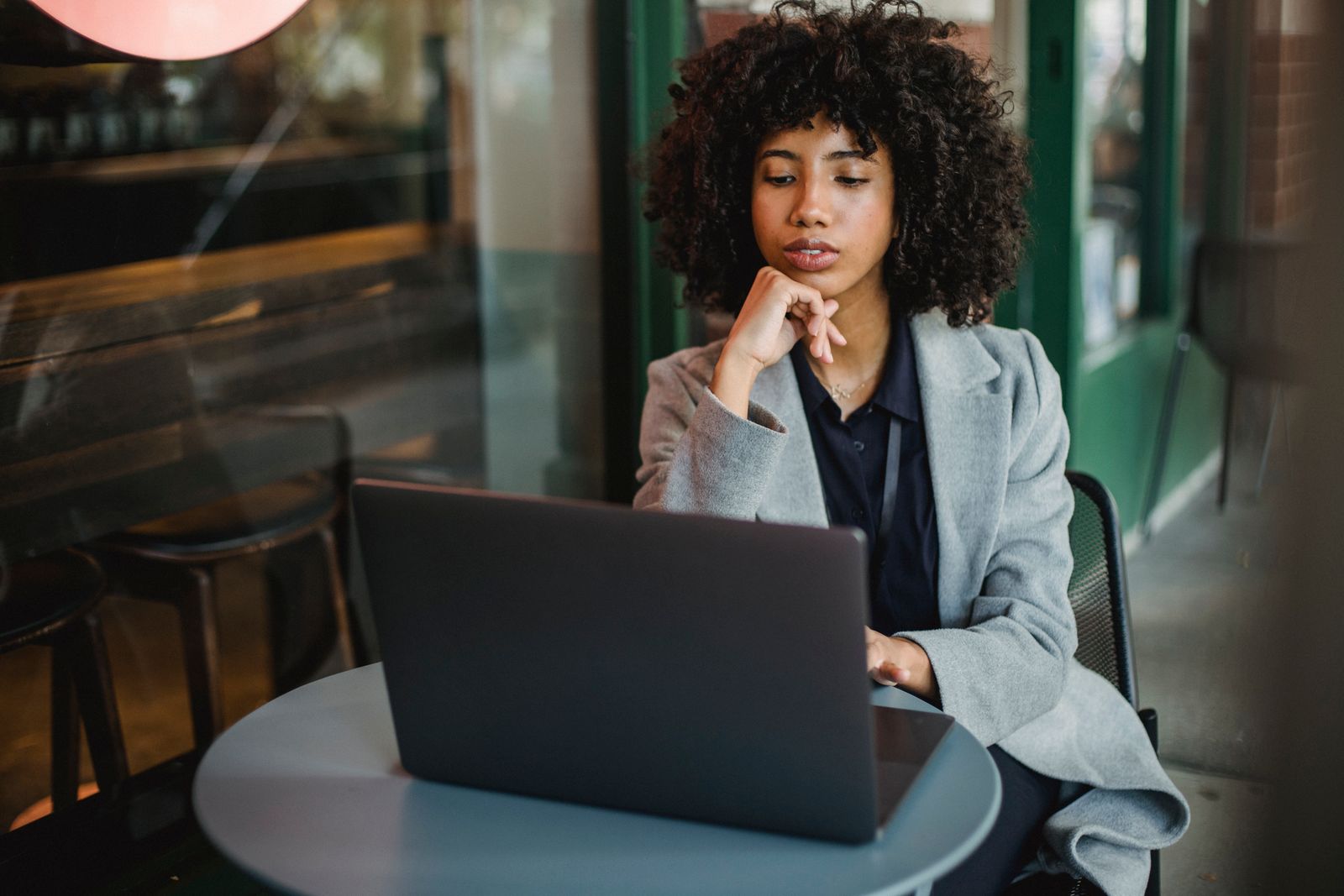 A small business owner working at a laptop in a bright modern office
